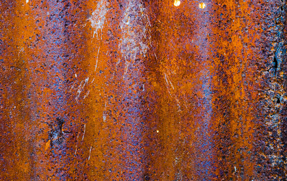 Textured surface with peeling blue paint