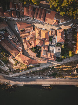 Aerial view of the historic riverside district with terracotta rooftops, narrow streets, and a road running along the Douro River in Porto, Porto, Portugal.