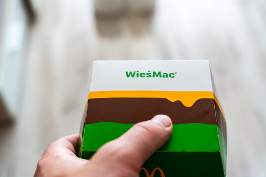 Warsaw, Poland - July 30, 2026: WiesMac burger box held in hand at McDonald's restaurant, showing limited edition rural-themed packaging with green and brown design