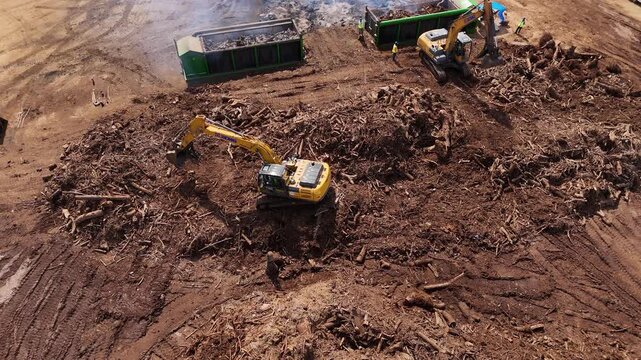 Tinian, Northern Mariana Islands - 26 June 2026: Aerial view of excavators clearing land and debris at a construction site.