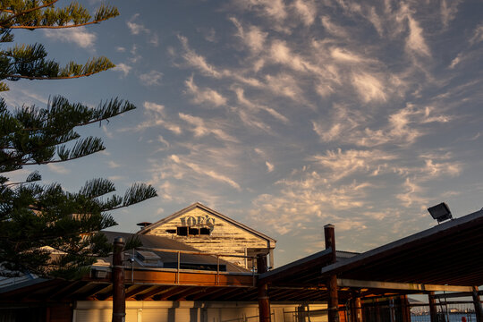View of Joe's Fish Shack at Bathers Beach under a dramatic sunset sky in City of Fremantle, Western Australia, Australia.