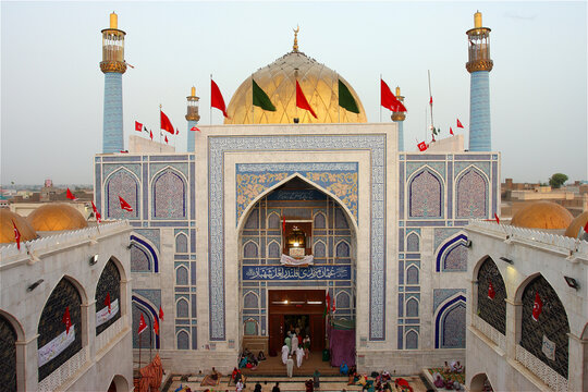 View of the Lal Shahbaz Qalandar Shrine with its golden dome, blue tilework, and flags during the annual Urs festival in Sehwan, Sindh, Pakistan.