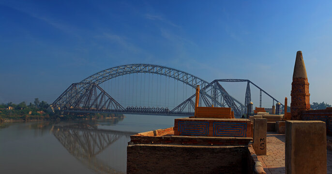 View of the historic Graves of Seven Sisters overlooking the Indus River and the iconic Lansdowne Bridge in Sukkur, Sindh, Pakistan.