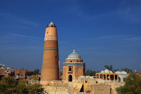 View of Masoom Shah Minara with its historic brick tower and blue-tiled dome set against a clear blue sky in Sukkur, Sindh, Pakistan.