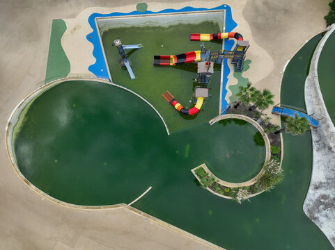 Seignosse, France - 23 September 2023: Aerial view of Seignosse Atlantic Park featuring colorful water slides and green swimming pools seen from above.