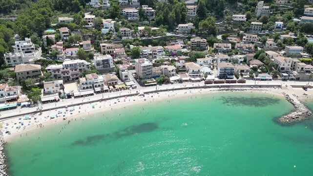 Aerial view of the coastal town of Port de Soller with its sandy beach, turquoise water, and hillside buildings in Port de Soller, Balearic Islands, Spain.