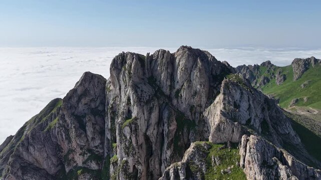 4K UHD Drone Flight Above Dramatic Rocky Mountain Ridge and Sea of Clouds.