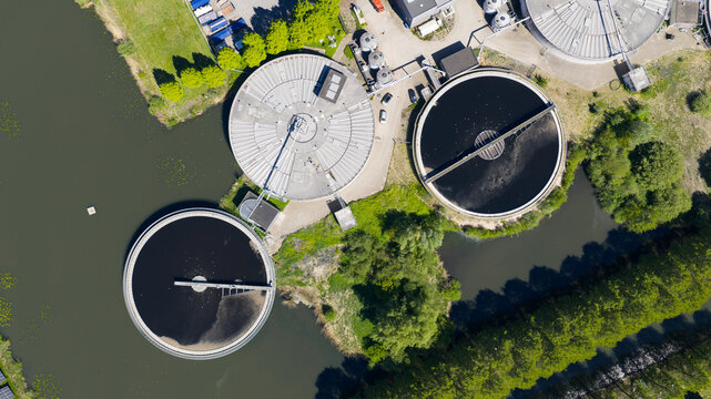 Aerial view of RWZI Leidsche Rijn wastewater treatment plant with circular sedimentation tanks and green surroundings in Utrecht, Utrecht, Netherlands.