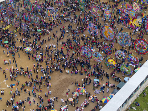 Aerial view of the Giant Kites of Sumpango festival, featuring colorful kites on a field with crowds of people in Sumpango, Sacatepequez Department, Guatemala.