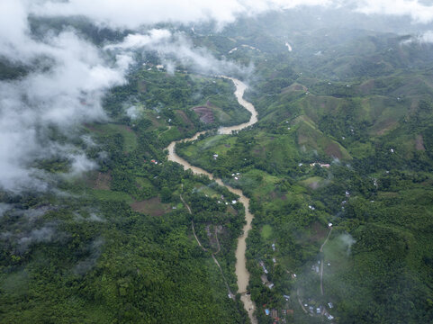 Aerial view of Semuc Champey with its winding river flowing through lush green mountains and dense tropical forest in San Agustin Lanquin, Alta Verapaz, Guatemala.