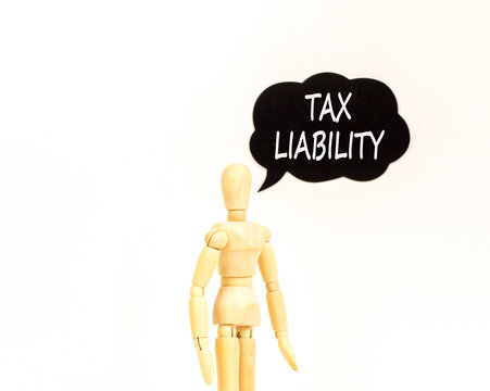 Tax liability words symbol. Concept words Tax liability on beautiful black speech bubble. Beautiful white background. Businessman model. Business and Tax liability words concept. Copy space.