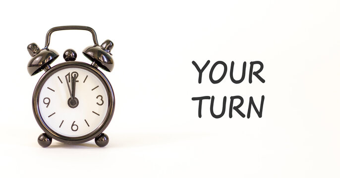 Your turn words symbol. Concept words Your turn on beautiful white paper. Beautiful white background. Black alarm clock. Business your turn motivational support concept. Copy space.