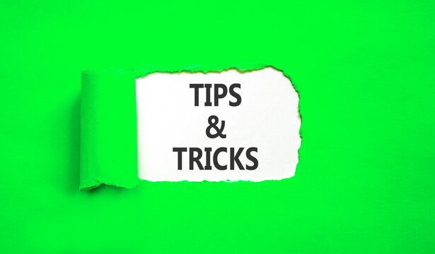 Tips and tricks words symbol. Concept words Tips and tricks on beautiful white paper. Beautiful green background. Business tips and tricks motivational support concept. Copy space.