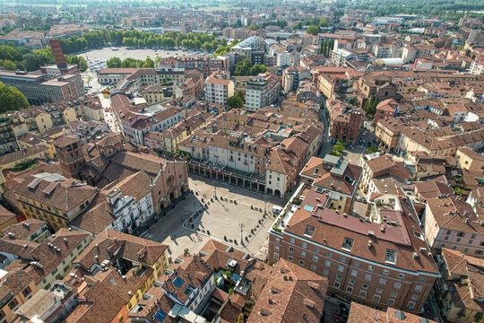 Aerial view of the historic Piazza San Secondo in Asti, featuring the medieval collegiate church, surrounding terracotta-roofed buildings, and urban architecture in Asti, Piedmont, Italy.