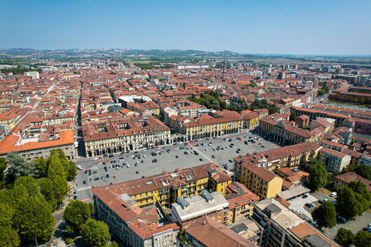 Aerial view of Piazza della Liberta surrounded by historic buildings and terracotta rooftops in Alessandria, Piedmont, Italy.