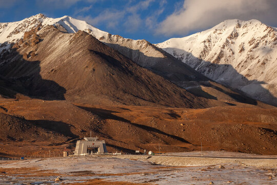 View of the Khunjerab Check Post at the Pakistan-China border on the Karakoram Highway, set against a backdrop of snow-capped mountains in Sost, Gilgit, Pakistan.