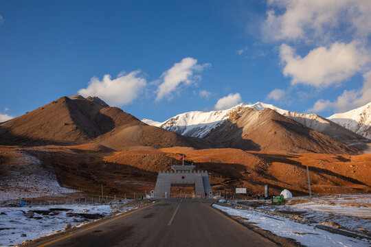 View of the Khunjerab Check Post on the Karakoram Highway at the Pakistan-China border, set against snow-capped mountains under a clear blue sky in Sost, Gilgit, Pakistan.