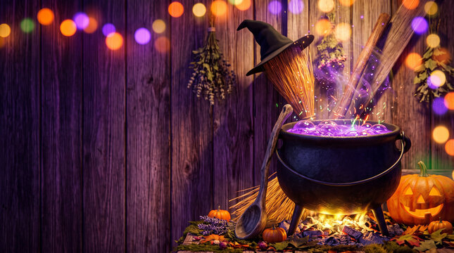 Witch's cauldron bubbling with potion surrounded by Halloween decorations  