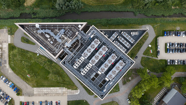 Aerial view of Digital Realty Amsterdam AMS17 data center with rooftop HVAC units, parking lots, and surrounding green space in Amsterdam, Noord-Holland, Netherlands.