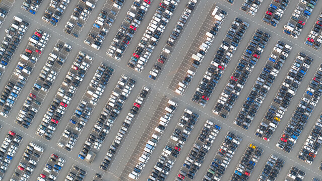 Aerial view of a large parking lot filled with numerous cars parked in neat rows in Waalwijk, North Brabant, Netherlands.