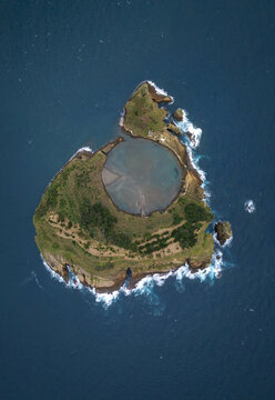 Aerial view of the volcanic islet Ilheu de Vila Franca do Campo with its circular crater lagoon surrounded by the Atlantic Ocean in Sao Pedro, Acores, Portugal.