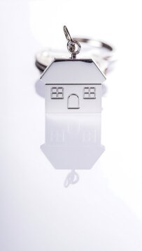 Modern white electric toothbrush with charging stand on white background.
