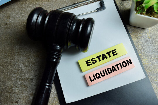 Concept of estate liquidation write on sticky notes and judge gavel isolated on Wooden Table. For asset sale probate administration debt settlement