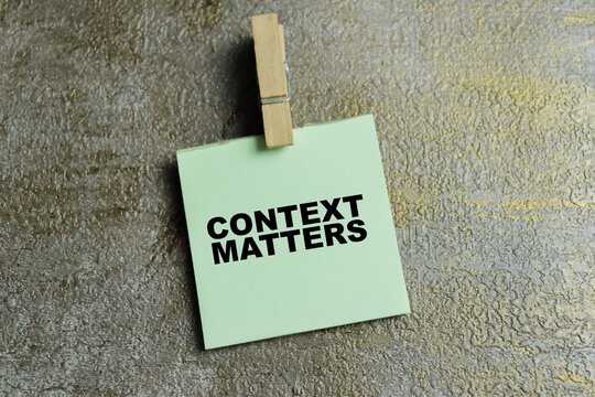 Concept of context matters write on sticky notes isolated on Wooden Table.
