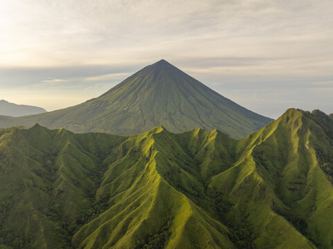 Aerial view of the volcanic Mount Inerie surrounded by lush green ridges and valleys, Inerie, Flores, Indonesia.