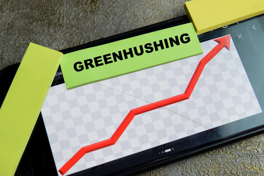 Concept of Greenhushing write on sticky notes isolated on Wooden Table. For corporate sustainability silence and ESG communication strategy