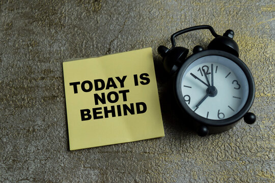 Concept of today is not behind write on sticky notes isolated on Wooden Table. For time anxiety and self compassion