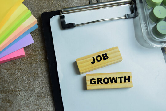 Concept of job growth text on wooden blocks. For employment trend and workforce expansion