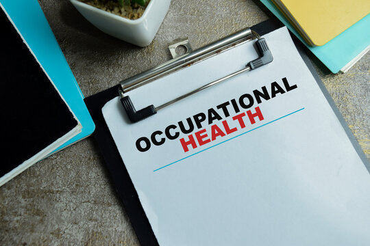 Concept of occupational health write on clipboard isolated on Wooden Table. For workspace compliance and wellness