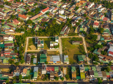 Aerial view of the town of Lien Son Lak near Lak Lake with dense residential rooftops, green spaces, and local roads in Lien Son Lak, Dak Lak, Vietnam.
