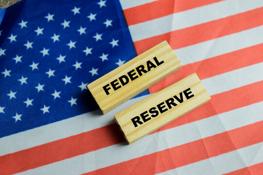 Concept of federal reserve text on wooden blocks with United States flag. For American central bank monetary policy