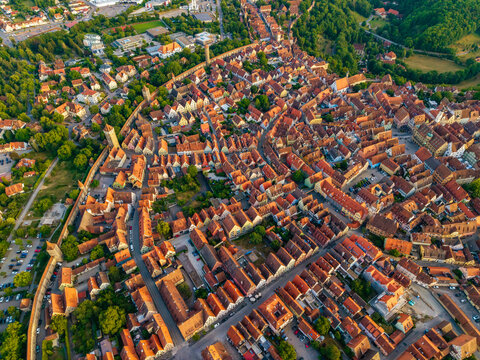 Aerial view of the historic town of Rothenburg ob der Tauber with dense red-tiled rooftops, medieval fortifications, and narrow streets in Rothenburg ob der Tauber, Bavaria, Germany.