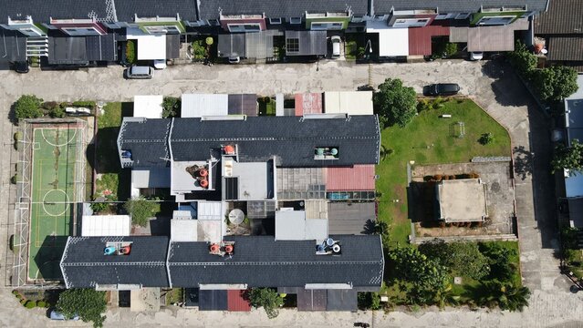 Aerial view of Jakasampurna residential area featuring rooftops, a small sports court, and green spaces in Bekasi Barat, West Java, Indonesia.