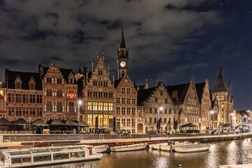 Fototapeta premium Illuminated Historic Guildhalls and Canal View at Night in Ghent, Belgium