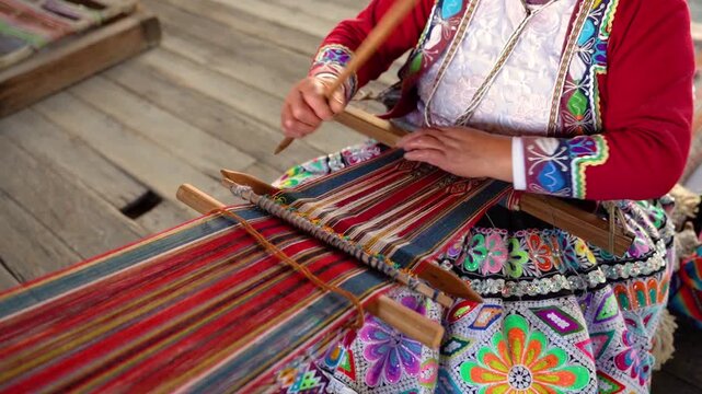 Close-up of an elderly Peruvian woman's hands knitting traditional Peruvian textile in slow motion, showcasing Andean craftsmanship, handmade weaving, cultural heritage, and artisan skills
