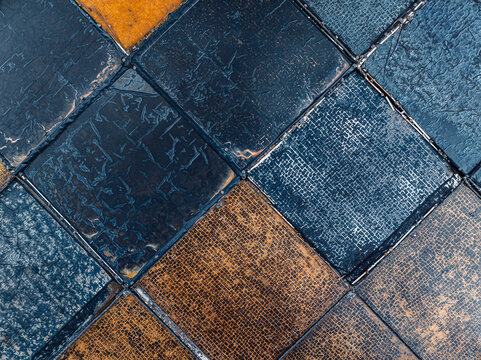 Aerial view of textured blue and orange square tiles of the old Tamarin salt pans arranged in a grid pattern, Mauritius.