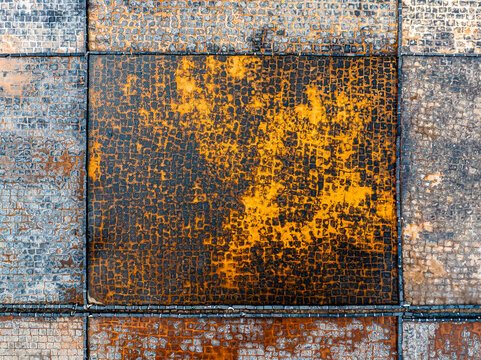 Aerial view of salt pans with vibrant orange and grey textured grid patterns in Mauritius.