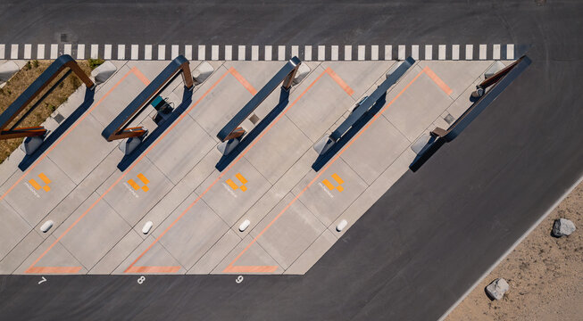Malataverne, France - 06 July 2026: Aerial view of the Milence heavy-duty electric truck charging hub with numbered charging bays and modern infrastructure.