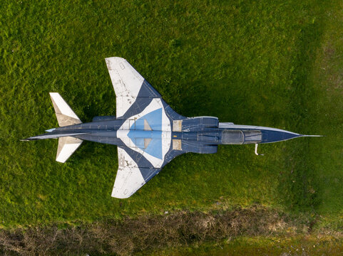Aerial view of a vintage fighter jet parked on the lush green grass at the Chateau de Savigny-les-Beaune, Savigny-les-Beaune, Bourgogne-Franche-Comte, France.