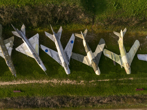 Aerial view of vintage fighter jets parked in a grassy field at the Chateau de Savigny-les-Beaune, showcasing an aviation collection in Savigny-les-Beaune, Bourgogne-Franche-Comte, France.