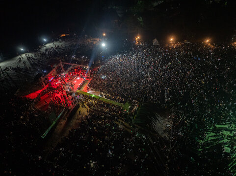 Aerial view of a large crowd gathered at a night concert with bright stage lighting illuminating the audience in Port Harcourt, Rivers State, Nigeria.