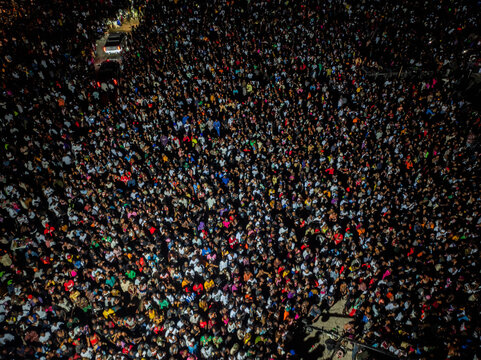 Aerial view of a massive crowd gathered at night in an urban area with street lighting illuminating the people in Port Harcourt, Rivers State, Nigeria.