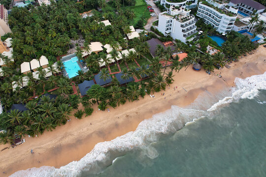 Aerial view of Long Beach with luxury resorts, lush palm trees, and white sand beach along the turquoise waters of the Gulf of Thailand in Phu Quoc, Kien Giang, Vietnam.