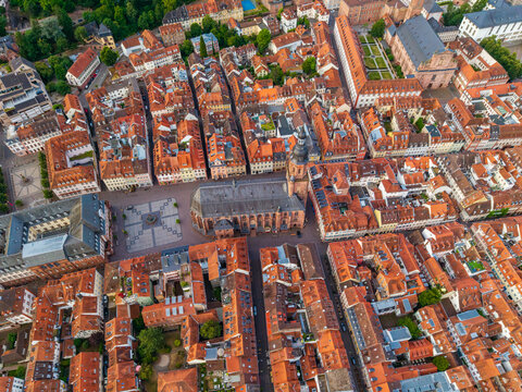 Aerial view of the Church of the Holy Spirit surrounded by historic red-tiled rooftops and narrow streets in the old town of Heidelberg, Baden-Wurttemberg, Germany.