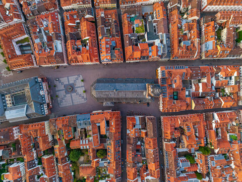 Aerial view of the Church of the Holy Spirit in the historic market square surrounded by dense red-tiled rooftops and narrow streets in Heidelberg, Baden-Wurttemberg, Germany.
