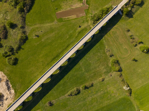 Aerial view of Tsar's Bridge spanning across the green fields in the countryside in Niksic, Opstina Niksic, Montenegro.